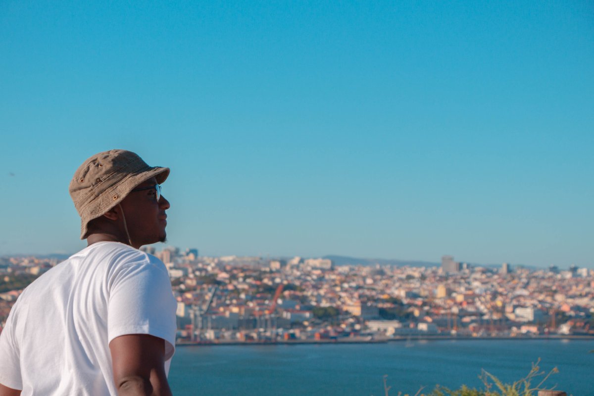 Man in white tshirt looking out at the sea