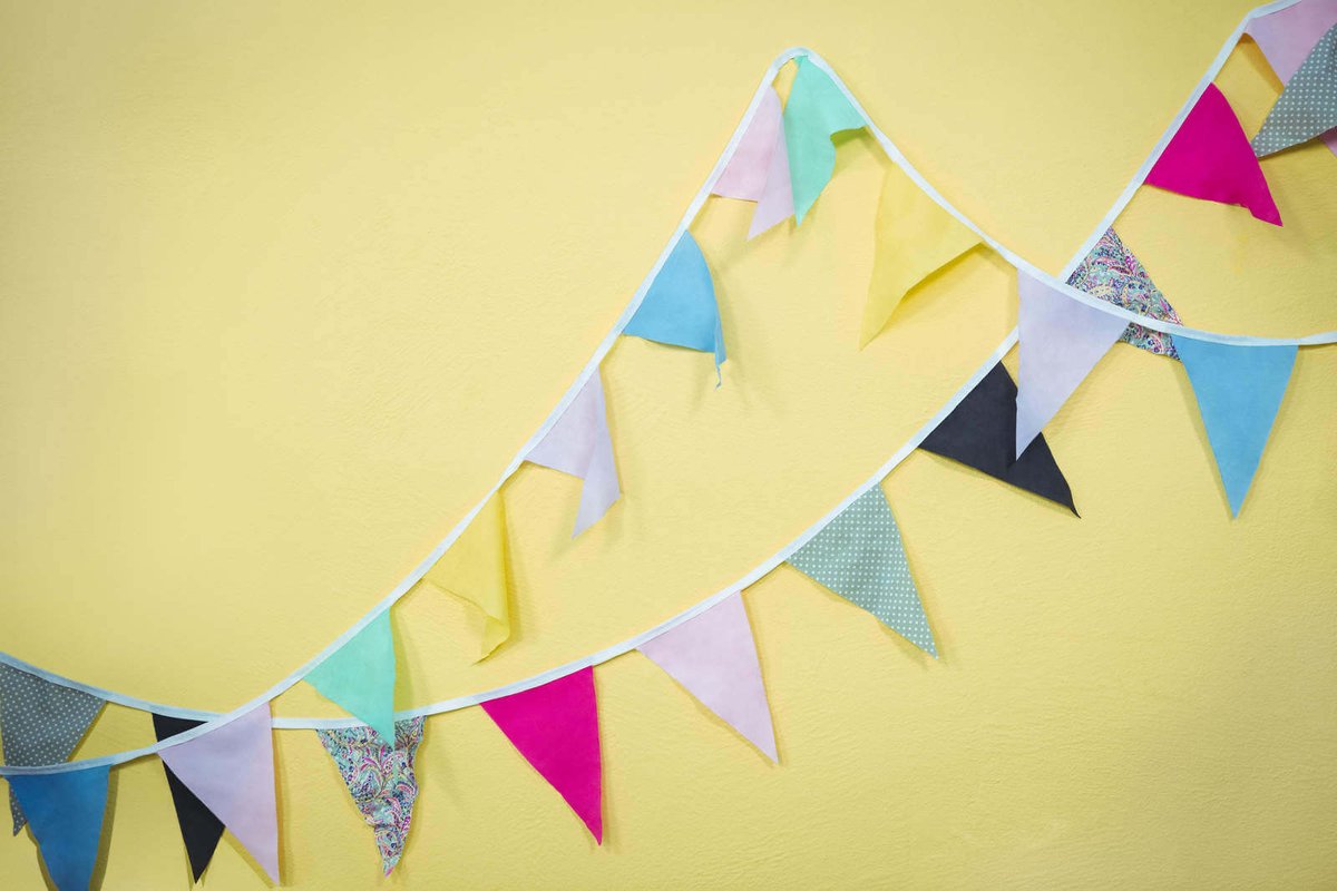 Bunting birthday decorations on a yellow wall