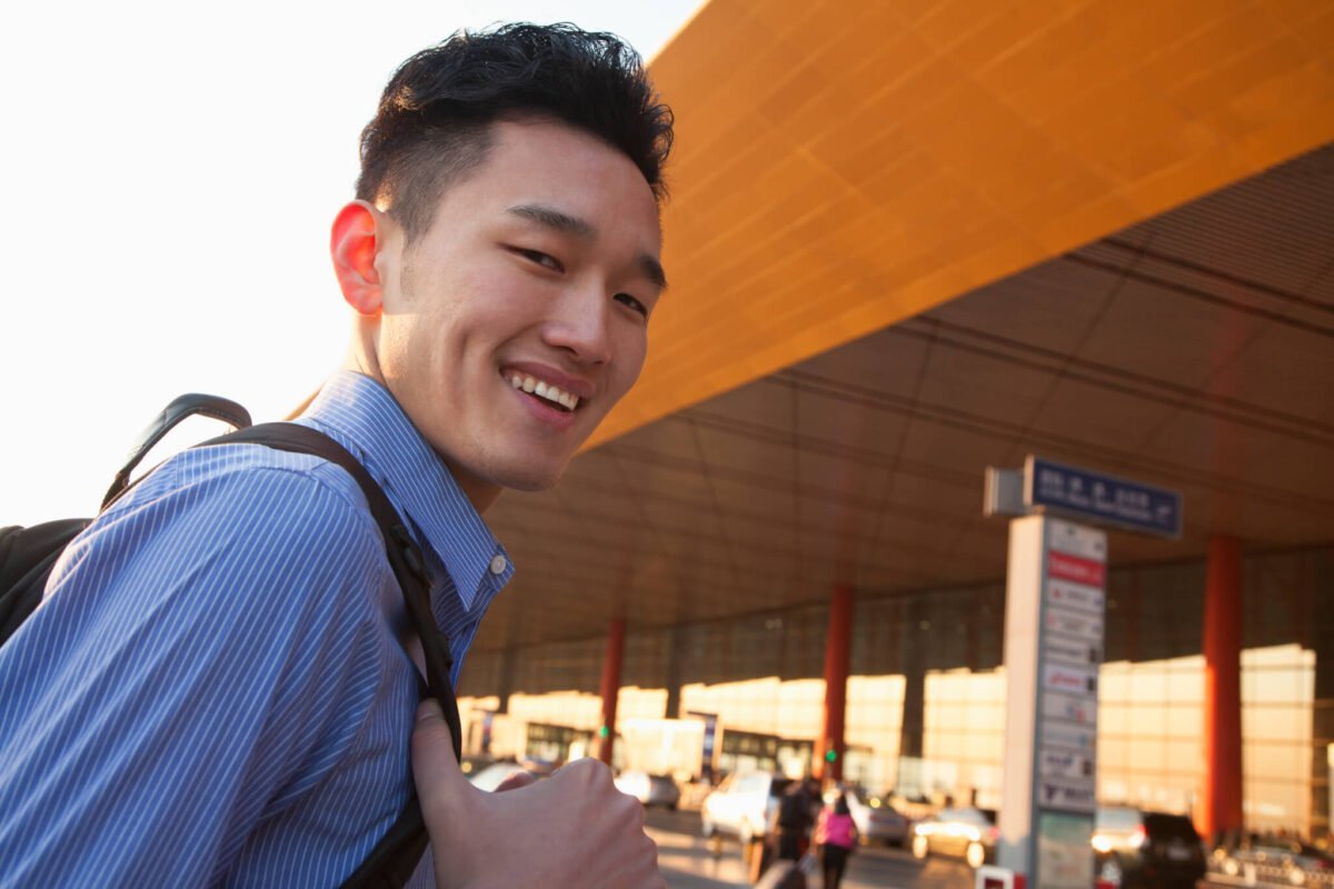 young traveler portrait in front of airport