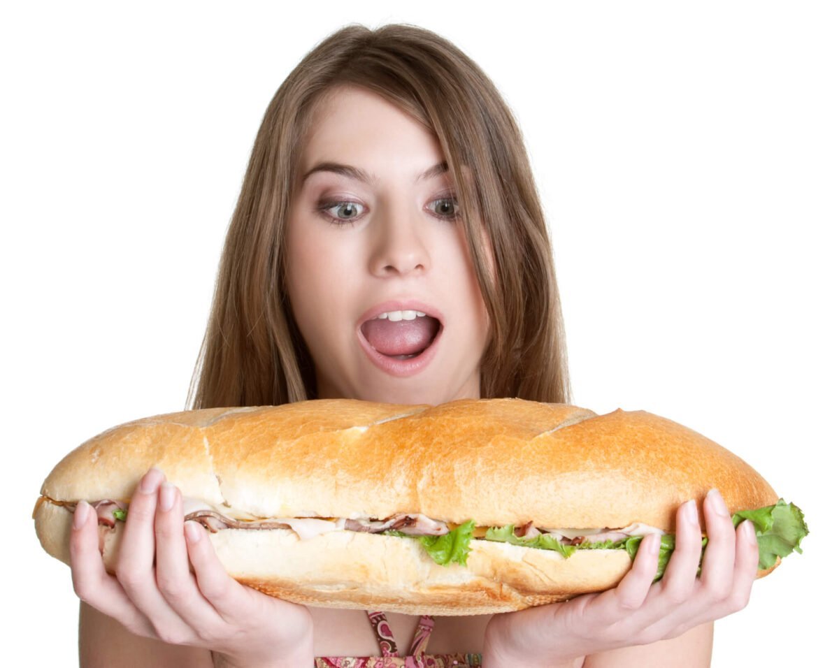 girl eating a large sandwich