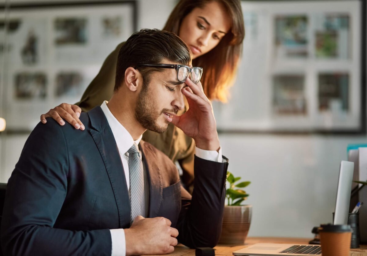 businessman stressed being comforted by woman