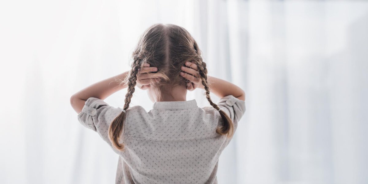Girl covering ears to hide noise