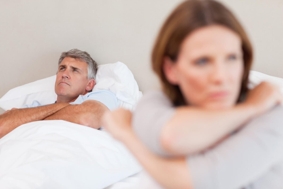 angry older couple in bed