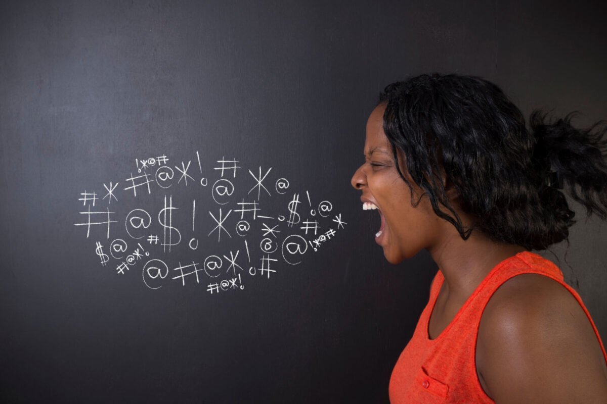 woman with anger management issues swearing at blackboard with tourettes