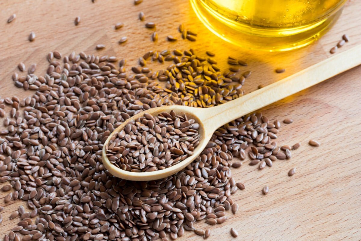 flaxseeds on a spoon on a wooden table