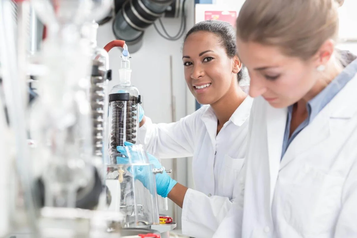 Group of scientists working with gloves and gowns in laboratory