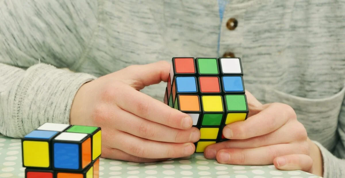 boy playing with rubik's cube