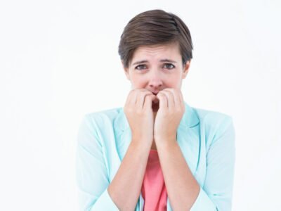 Pretty brunette biting nails with anxiety