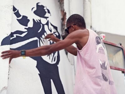 Creative expression. a young graffiti artist painting a design on a wall