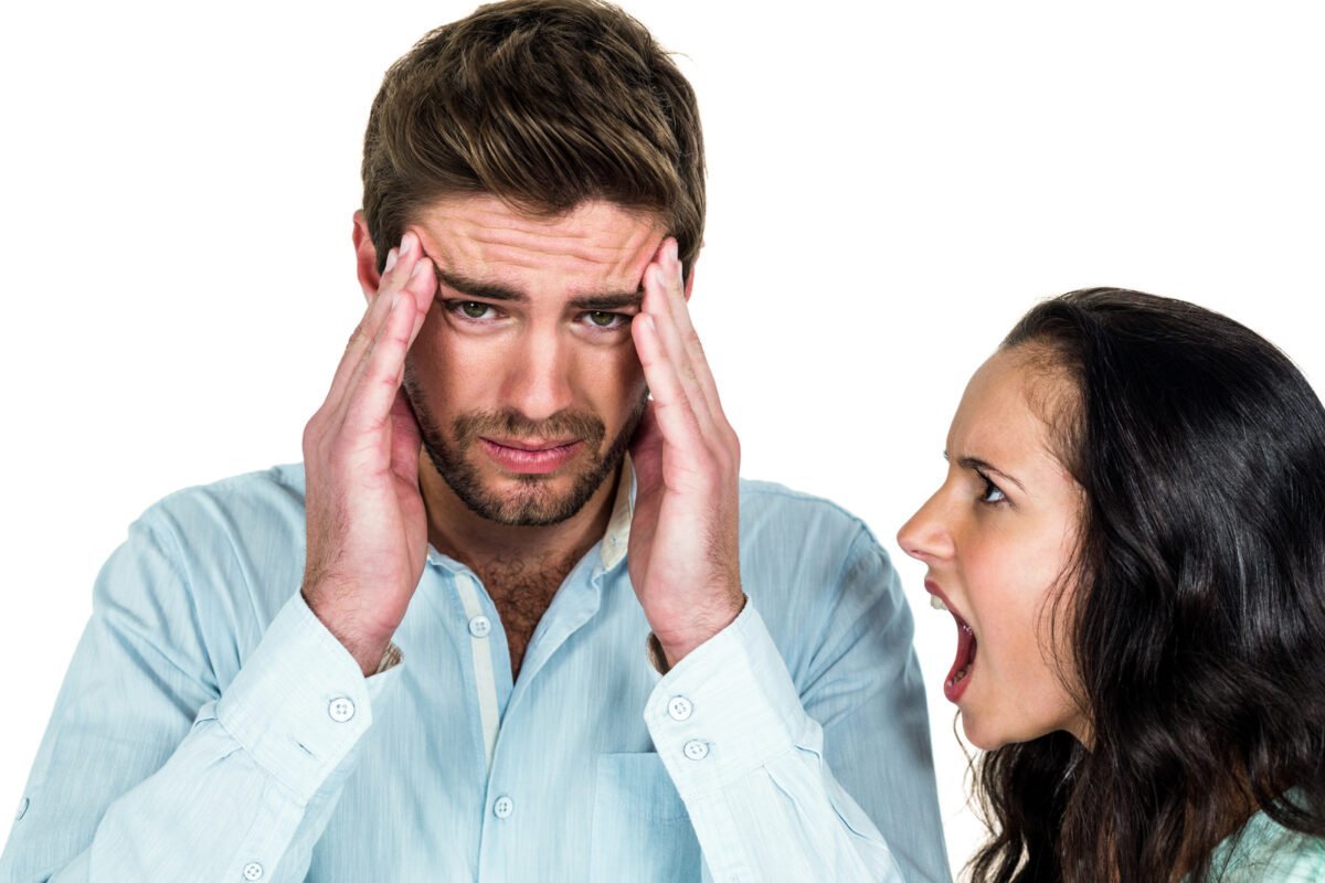 Woman shouting at man with hands on his head to cope with stress headache