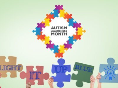 autism puzzle piece for autism awareness month with hands holding up the words light it up blue