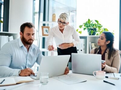 body doubling to make the deadline. a group of businesspeople working together in an office