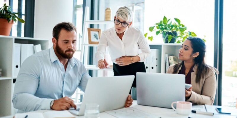 body doubling to make the deadline. a group of businesspeople working together in an office