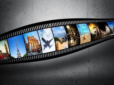 Film strip with colorful, vibrant photographs on grunge wall. Travel theme.
