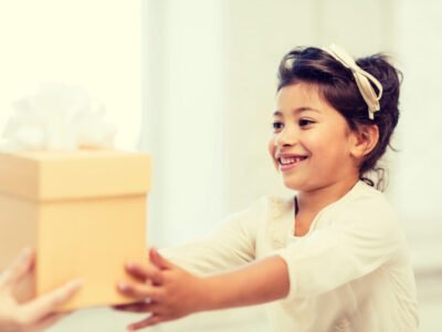 young girl receiving a gift of a calm down kit box