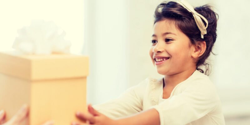 young girl receiving a gift of a calm down kit box