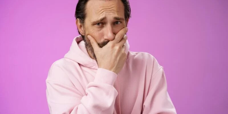 Shocked upset handsome mature bearded man hear terrible news griefing suffer sorrow express empathy gasping hold hand mouth reacting lose cringing crying cannot control emotions, purple background