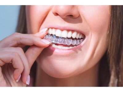 Woman with perfect smile wearing invisible dental aligners for dental correction. High quality photo