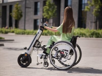 Woman using a portable mobility scooter on the street