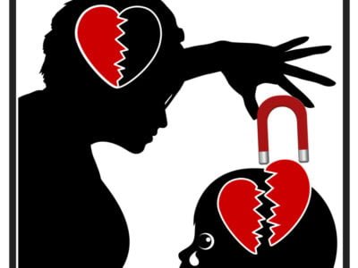 silhouette of narcissistic mother pulling heart out of child's brain with magnet to symbolise pain