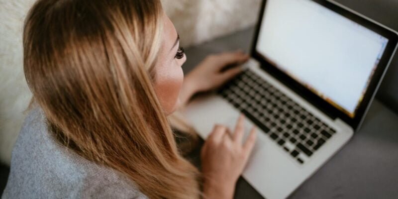girl creating social media content on laptop