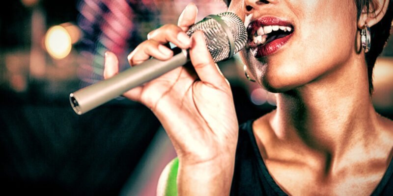 close-up of woman singing in bar into microphone
